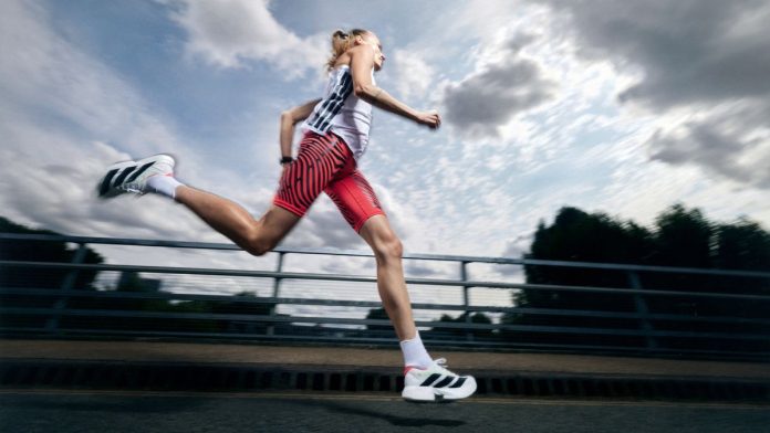 Woman running in the Adidas Adizero Adios Pro 4