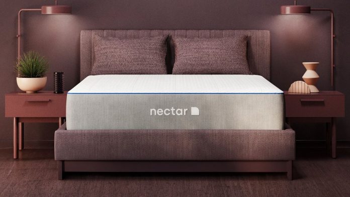 Nectar Hybrid Mattress review, featuring a Nectar Hybrid Mattress on an upholstered bed frame between a pair of end tables. 