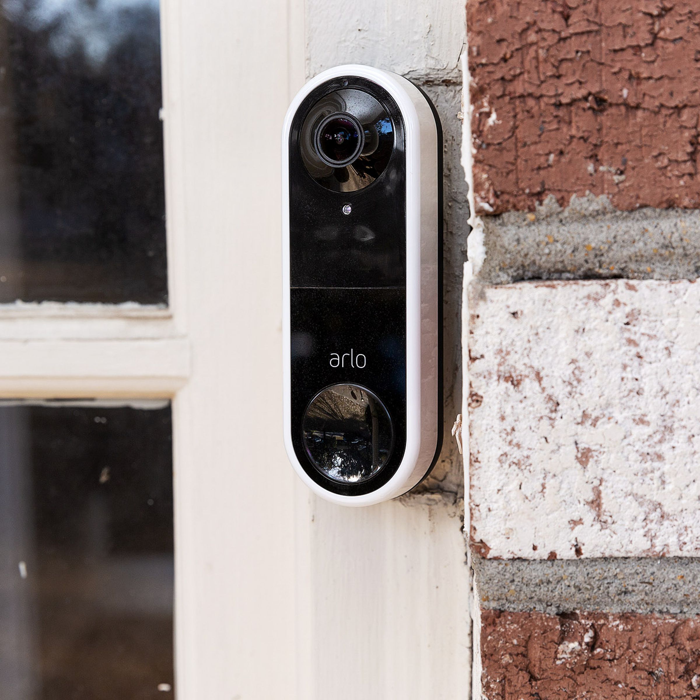 Arlo's Essential wired video doorbell installed on a front door.