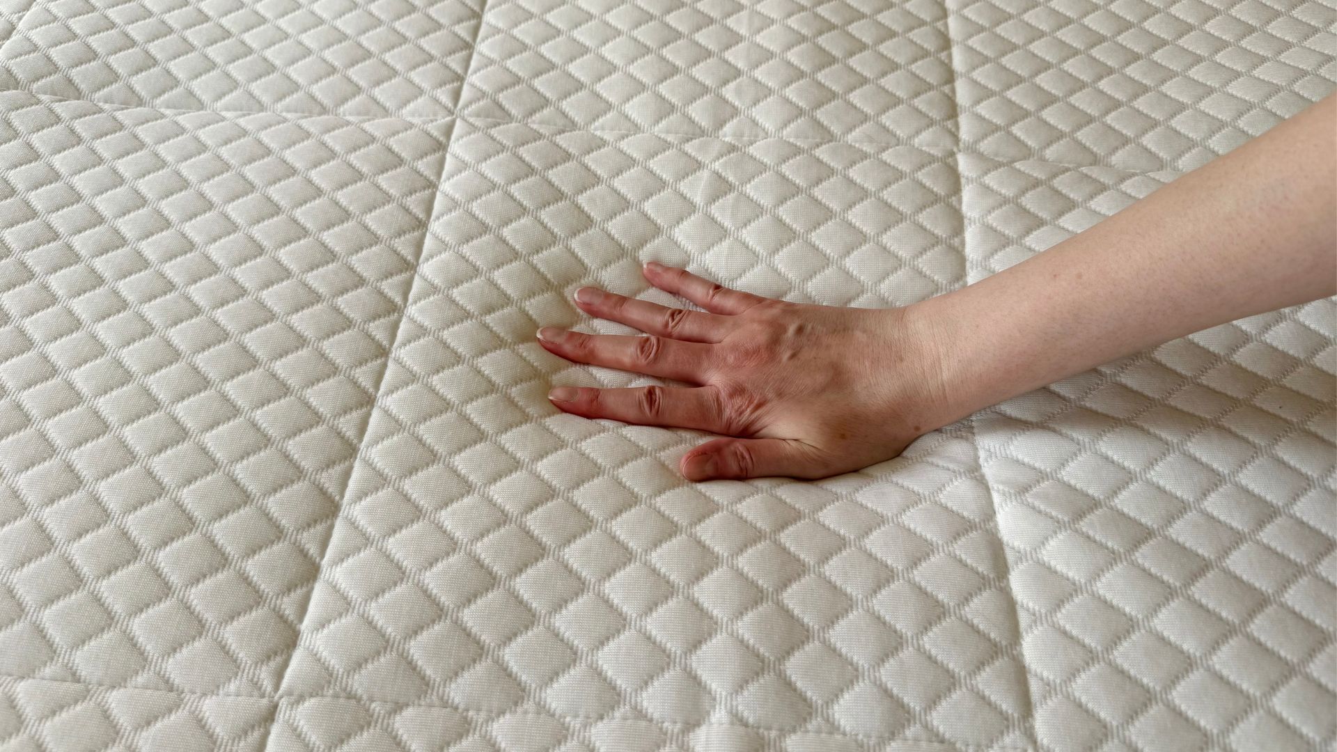 Our lead tester places her hand on the Nectar Hybrid Mattress