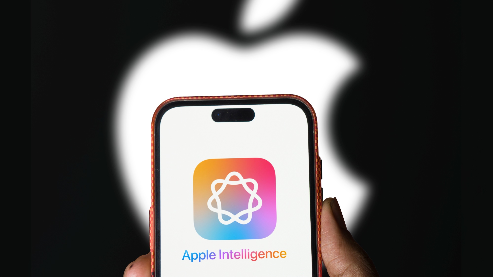 Λογότυπο Apple Intelligence στο iPhone με το λογότυπο της Apple στο παρασκήνιο