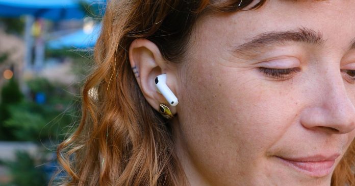 A hands-on photo of Apple’s AirPods 4 wireless earbuds.