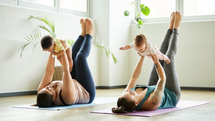 a photo of two mothers exercising with their babies