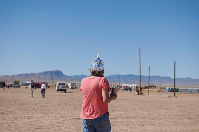 A woman wears a tinfoil hat at Alienstock festival on the "Extraterrestrial Highway" in Rachel, Nevada on September 20, 2019.