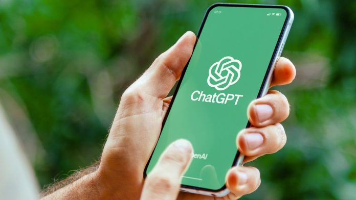 ChatGPT logo on a smartphone screen being held outside